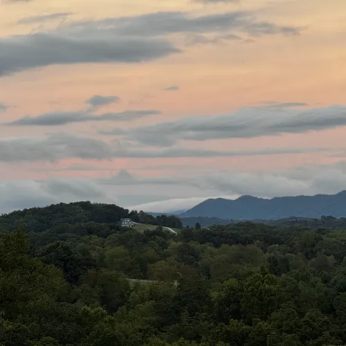 Photo: clouds pouring down the side of a mountain.