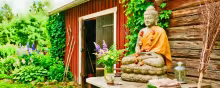 Illustration of a garden Buddha in front of a red barn